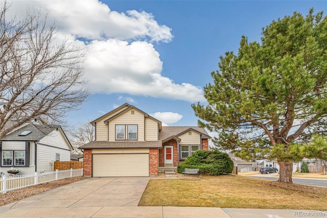 split level home with driveway, brick siding, an attached garage, and fence