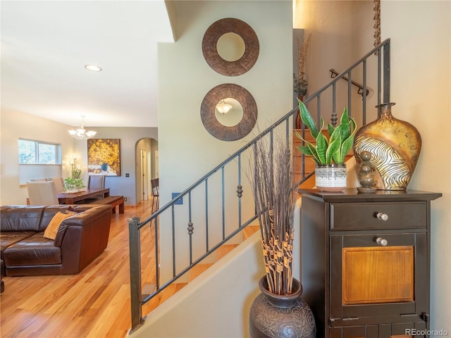 1033 H St, Salida, CO 81201 - stairs featuring arched walkways, wood finished floors, a chandelier, and recessed lighting
