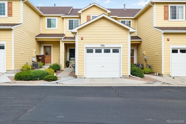 view of front facade with central AC and a garage