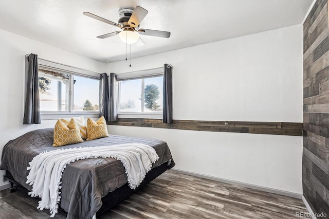 bedroom featuring baseboards, a ceiling fan, and wood finished floors