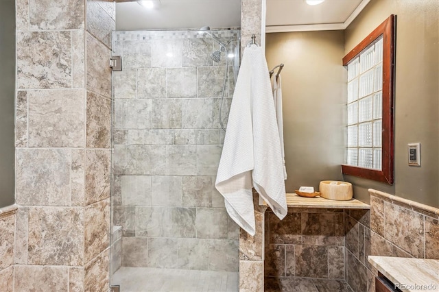 bathroom featuring walk in shower, tile walls, and wainscoting