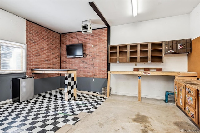 interior space with brick wall and tile patterned floors