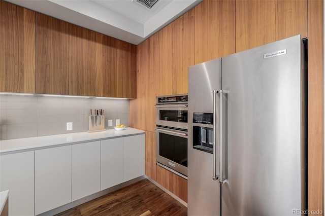 4200 W 17th Ave Unit 625, Denver, CO 80204 - kitchen with appliances with stainless steel finishes, modern cabinets, light countertops, backsplash, and dark wood finished floors