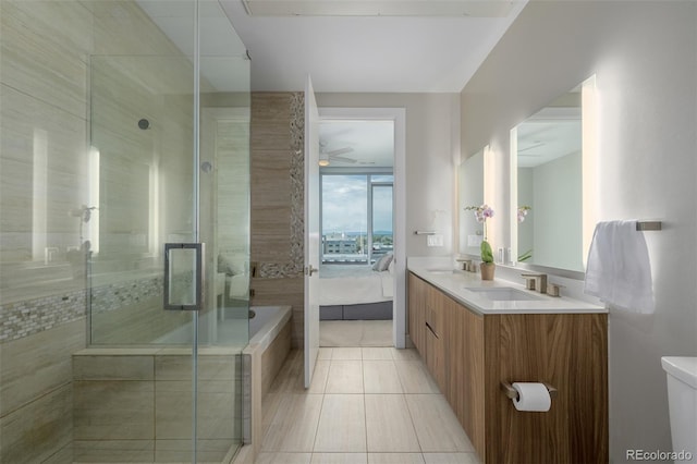 4200 W 17th Ave Unit 625, Denver, CO 80204 - ensuite bathroom with double vanity, a shower stall, tile patterned flooring, and ceiling fan