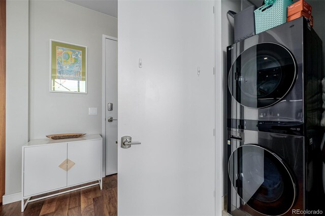 4200 W 17th Ave Unit 625, Denver, CO 80204 - washroom featuring estacked washer and dryer and wood finished floors