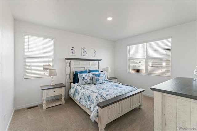 carpeted bedroom with visible vents and baseboards