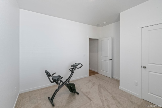 workout area with carpet flooring and baseboards