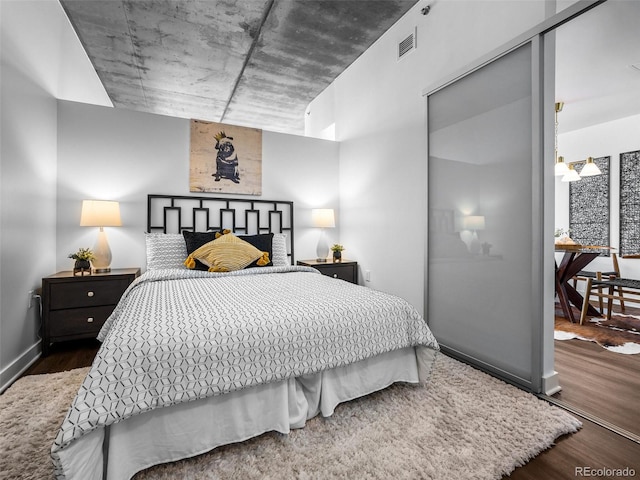 bedroom with dark wood-type flooring