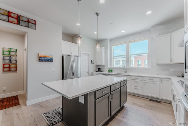 2282 Old Rail Way, Superior, CO 80027 - kitchen featuring stainless steel fridge, tasteful backsplash, white cabinetry, and recessed lighting