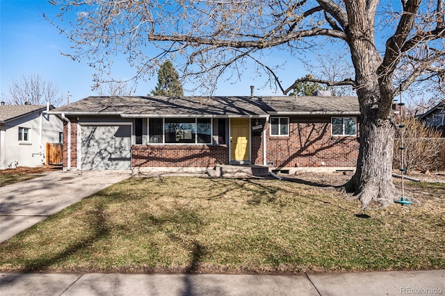 ranch-style home featuring a front lawn, brick siding, concrete driveway, and an attached garage