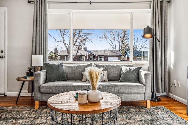 living area featuring wood finished floors and baseboards