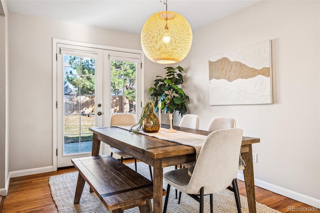 dining room with baseboards and wood finished floors