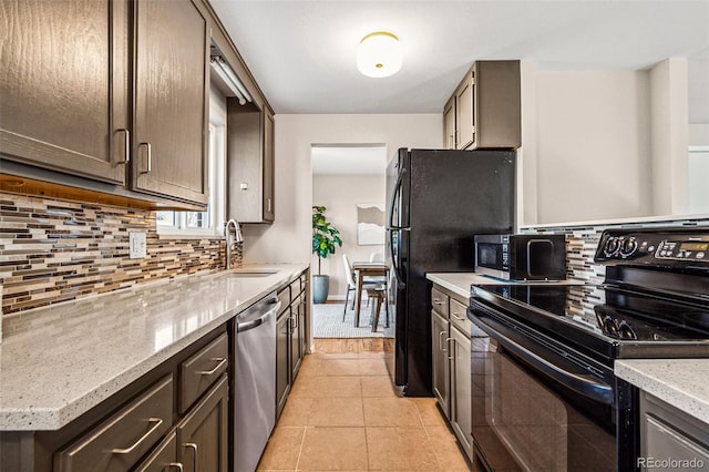 kitchen featuring black range with electric cooktop, dishwasher, decorative backsplash, light tile patterned flooring, and a sink