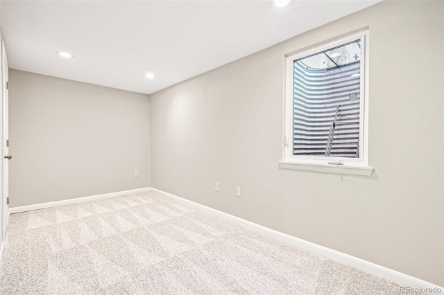 empty room featuring carpet flooring, recessed lighting, and baseboards