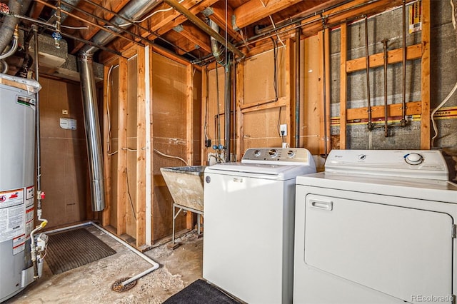 laundry room featuring gas water heater, a sink, laundry area, and washing machine and clothes dryer