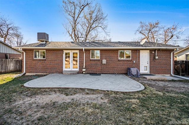 back of property featuring french doors, a patio, brick siding, and fence