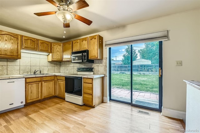 11891 Gaylord Way, Northglenn, CO 80233 - kitchen with range with electric cooktop, dishwasher, backsplash, light wood finished floors, and a ceiling fan