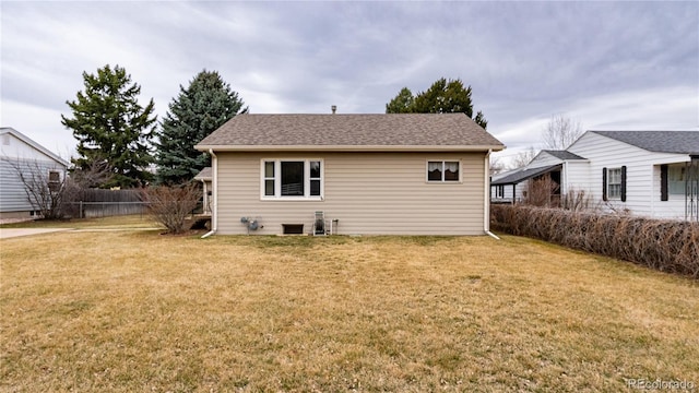 4115 S Clarkson St, Englewood, CO 80113 - rear view of property with fence, roof with shingles, and a yard