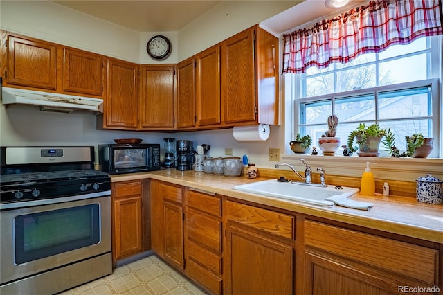 4115 S Clarkson St, Englewood, CO 80113 - kitchen featuring a sink, black microwave, light countertops, under cabinet range hood, and stainless steel gas range oven