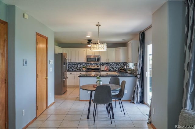 9927 Aftonwood St, Highlands Ranch, CO 80126 - kitchen with appliances with stainless steel finishes, dark countertops, decorative backsplash, and light tile patterned flooring