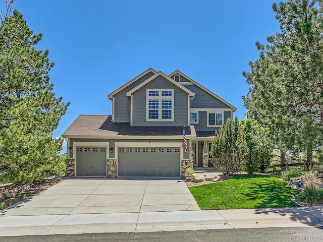 1674 Bent Grass Cir, Castle Rock, CO 80109 - craftsman house featuring driveway, a front lawn, a garage, an attached garage, and stone siding