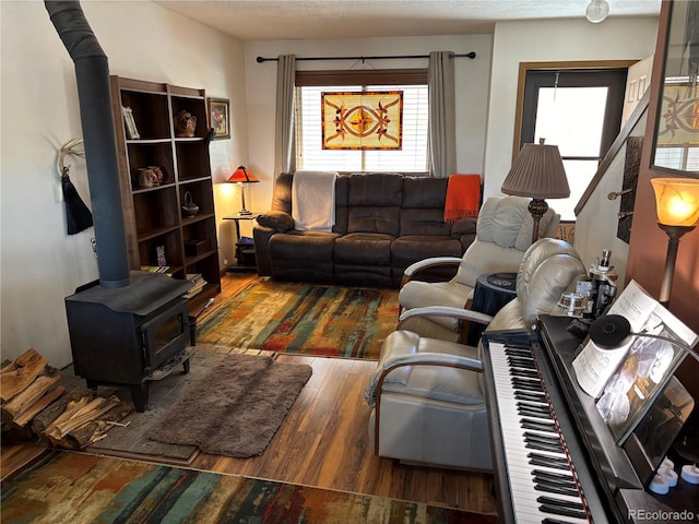 9 Granada Ct Unit 15, Westcliffe, CO 81252 - living area featuring wood finished floors, a wood stove, and healthy amount of natural light