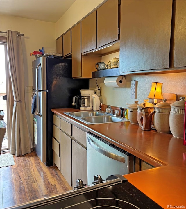 9 Granada Ct Unit 15, Westcliffe, CO 81252 - kitchen featuring a sink, stainless steel dishwasher, light wood-type flooring, and open shelves