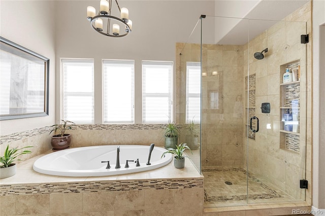 bathroom featuring a notable chandelier and plus walk in shower