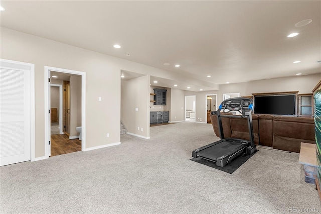 exercise room featuring light colored carpet