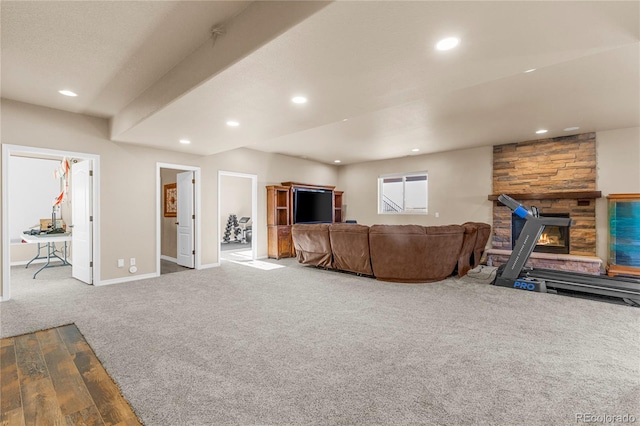 living room featuring carpet and a fireplace