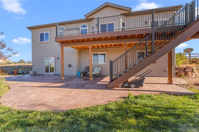 back of house with a patio area and a wooden deck