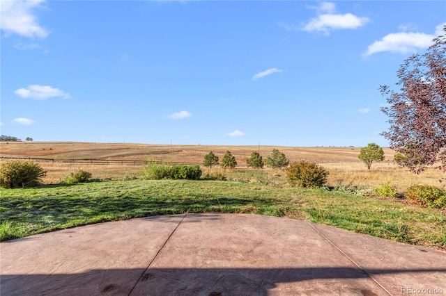 view of yard featuring a patio and a rural view