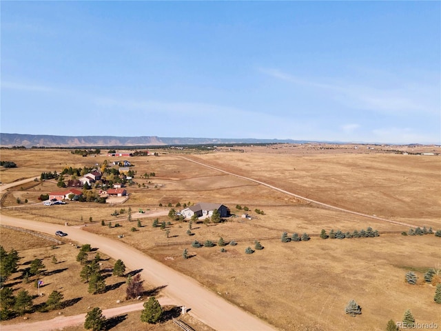 birds eye view of property featuring a mountain view and a rural view