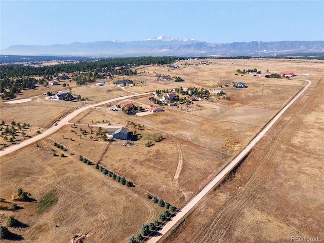 birds eye view of property with a mountain view and a rural view