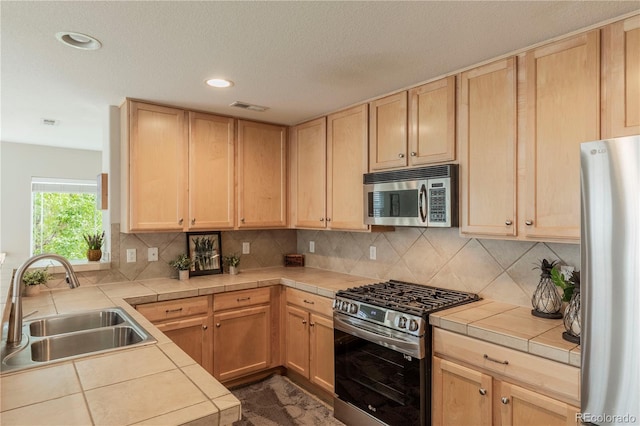 9760 Mayfair St Unit A, Englewood, CO 80112 - kitchen featuring stainless steel appliances, light brown cabinetry, and recessed lighting