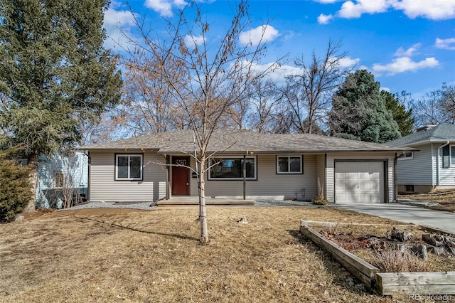 ranch-style home with a garage, concrete driveway, a shingled roof, and a front lawn