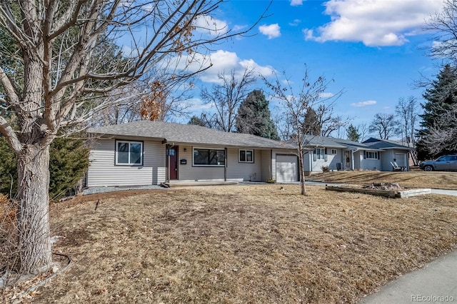 ranch-style house with a garage and a front lawn