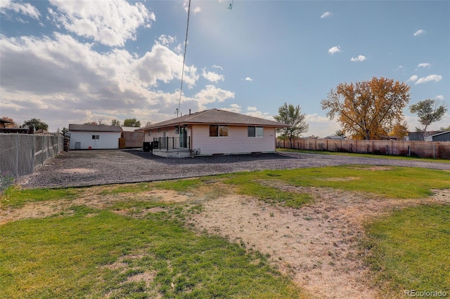 back of house with a wooden deck and a yard