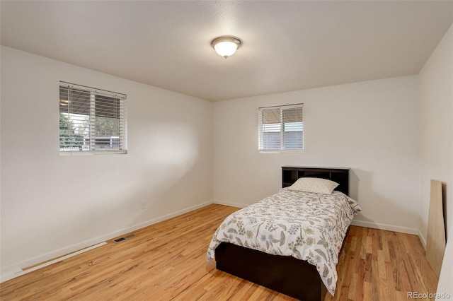 bedroom with wood-type flooring