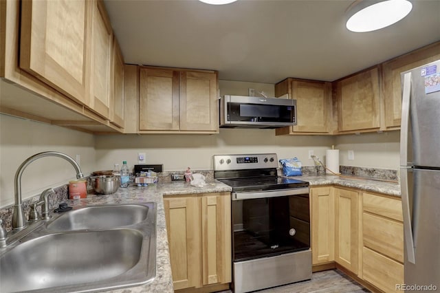 kitchen with stainless steel appliances, sink, and light brown cabinets