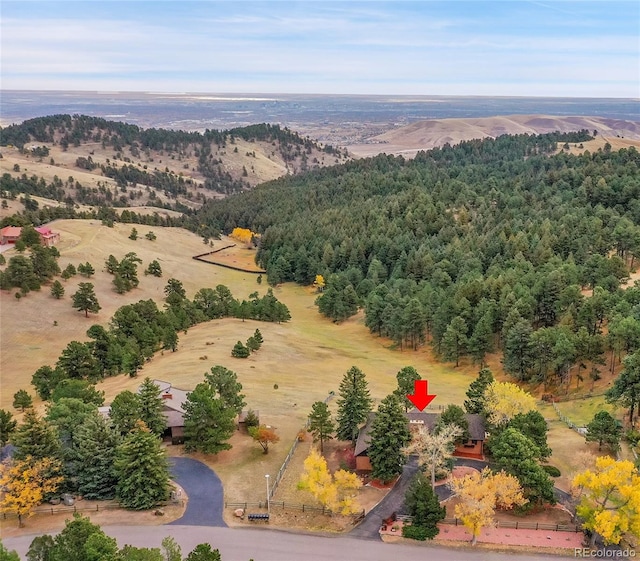 birds eye view of property featuring a wooded view