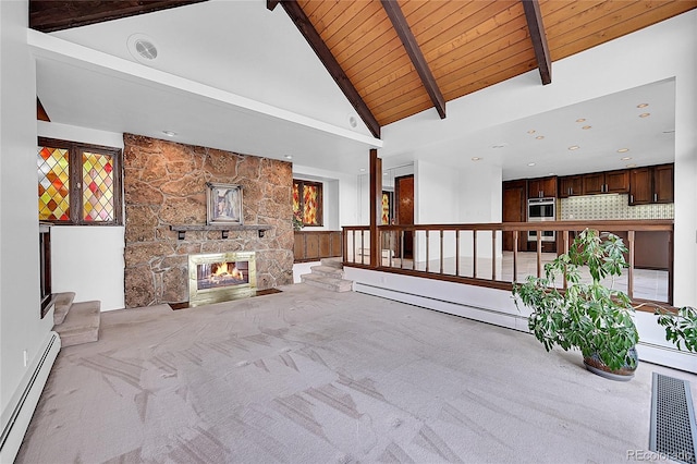 unfurnished living room with a baseboard radiator, a fireplace, visible vents, and carpet flooring