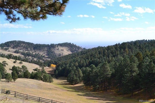 mountain view featuring a rural view and a wooded view