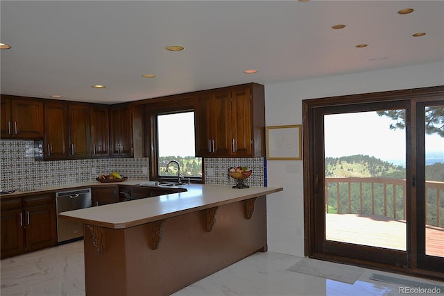 21849 Cabrini Blvd, Golden, CO 80401 - kitchen with stainless steel dishwasher, a peninsula, light marble finish floors, a breakfast bar, and recessed lighting