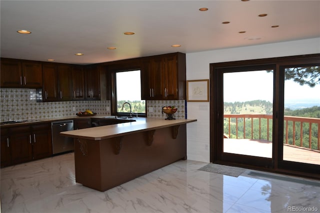 21849 Cabrini Blvd, Golden, CO 80401 - kitchen with stainless steel dishwasher, a peninsula, tasteful backsplash, a breakfast bar, and dark brown cabinets