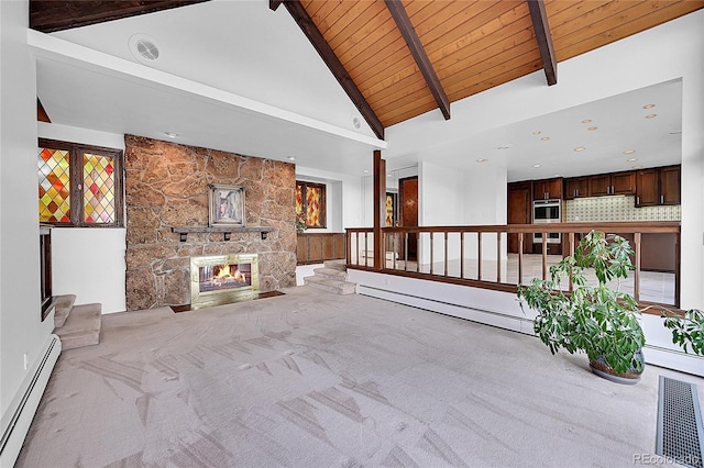 21849 Cabrini Blvd, Golden, CO 80401 - unfurnished living room with a baseboard heating unit, carpet floors, a wooden ceiling with exposed beams, a stone fireplace, and high vaulted ceiling