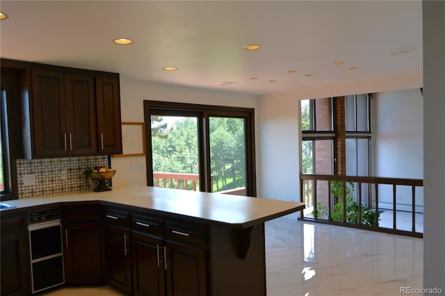 21849 Cabrini Blvd, Golden, CO 80401 - kitchen with a peninsula, tasteful backsplash, light countertops, recessed lighting, and baseboard heating