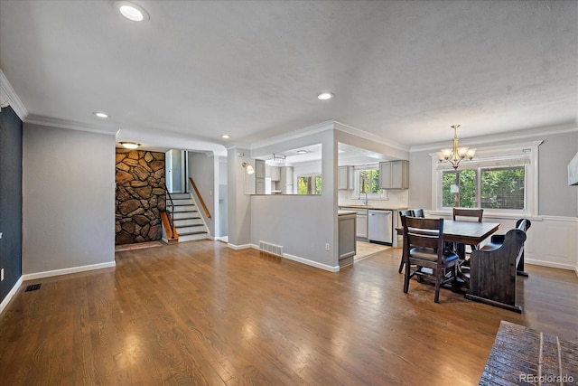 9350 Raleigh Ct, Westminster, CO 80031 - dining room with a chandelier, ornamental molding, stairs, recessed lighting, and wood finished floors