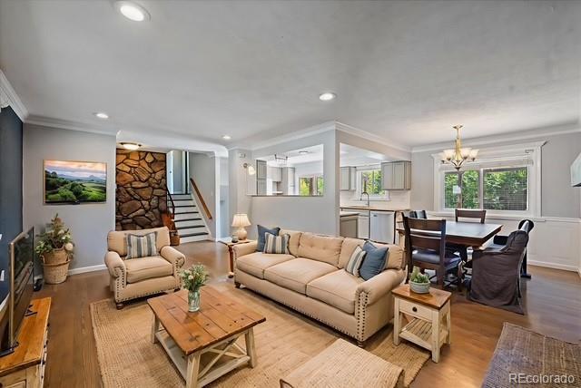 9350 Raleigh Ct, Westminster, CO 80031 - living area with ornamental molding, a chandelier, light wood-style floors, recessed lighting, and stairway