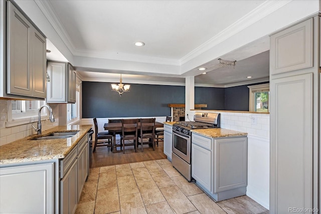 9350 Raleigh Ct, Westminster, CO 80031 - kitchen featuring stainless steel range with gas stovetop, crown molding, gray cabinets, tasteful backsplash, and a chandelier
